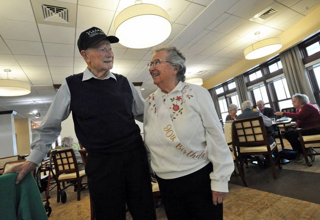 Residents celebrating a birthday in a common area.