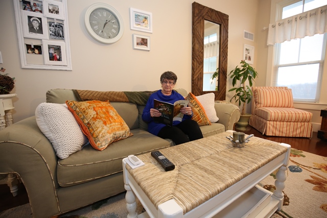 Resident reading in cozy living room
