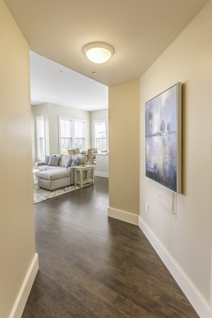 Well-lit hallway leading to a living area