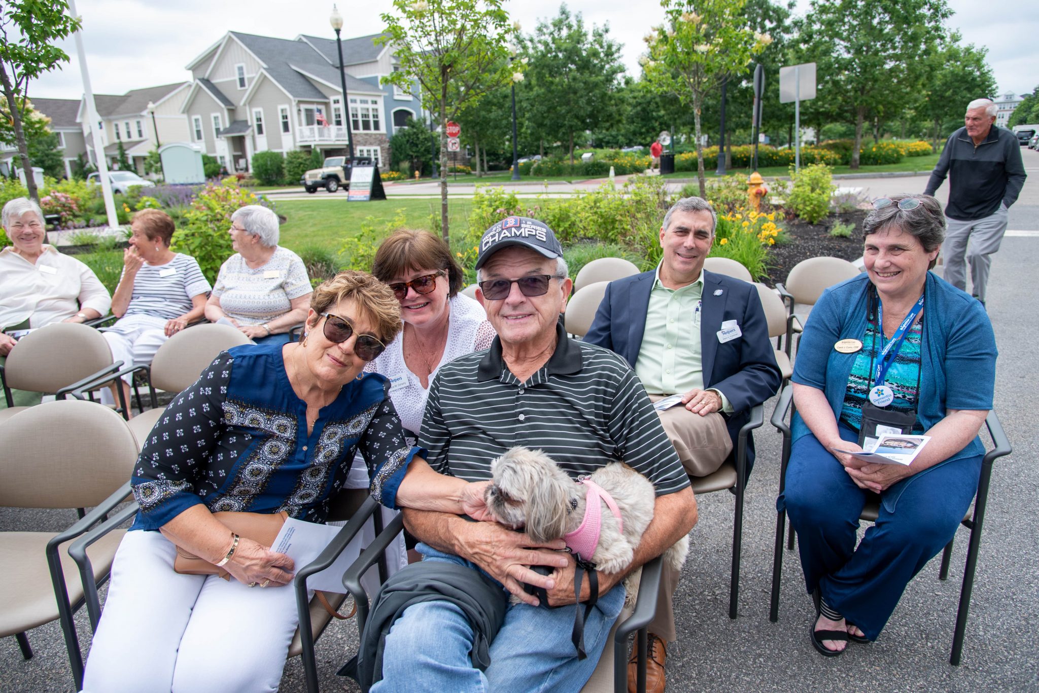 Residents enjoying an outdoor gathering with a dog.