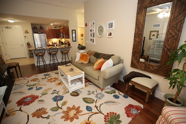 Cozy living room with floral rug and comfortable seating.