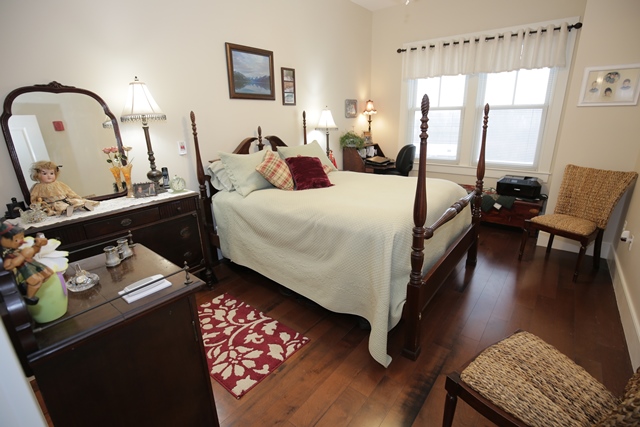 A cozy resident bedroom with warm lighting.