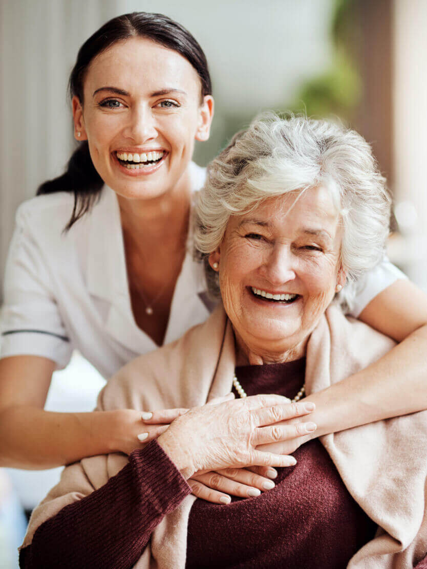 Caregiver and resident smiling together