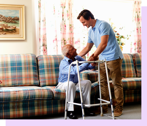 Senior man assisted by caregiver in living room