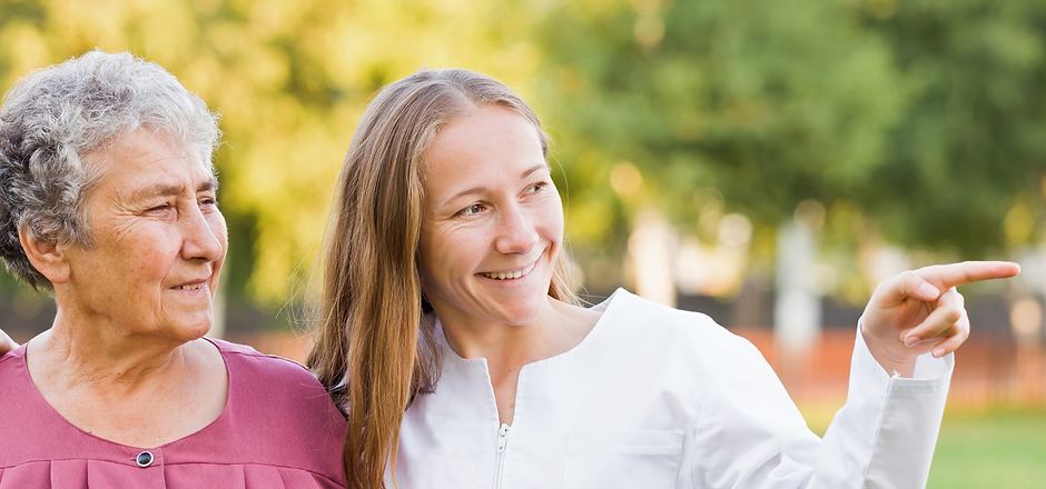 A caregiver and resident enjoying an outdoor moment