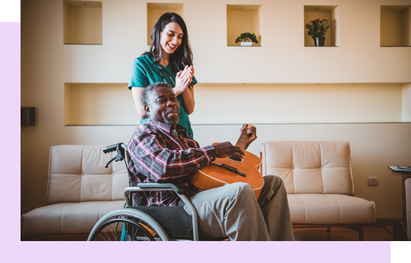 Staff member engaging with a resident in a lounge.