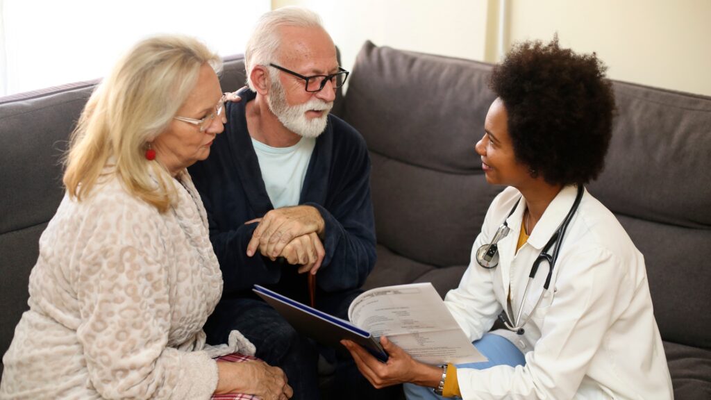 Caregiver interacting with two senior residents