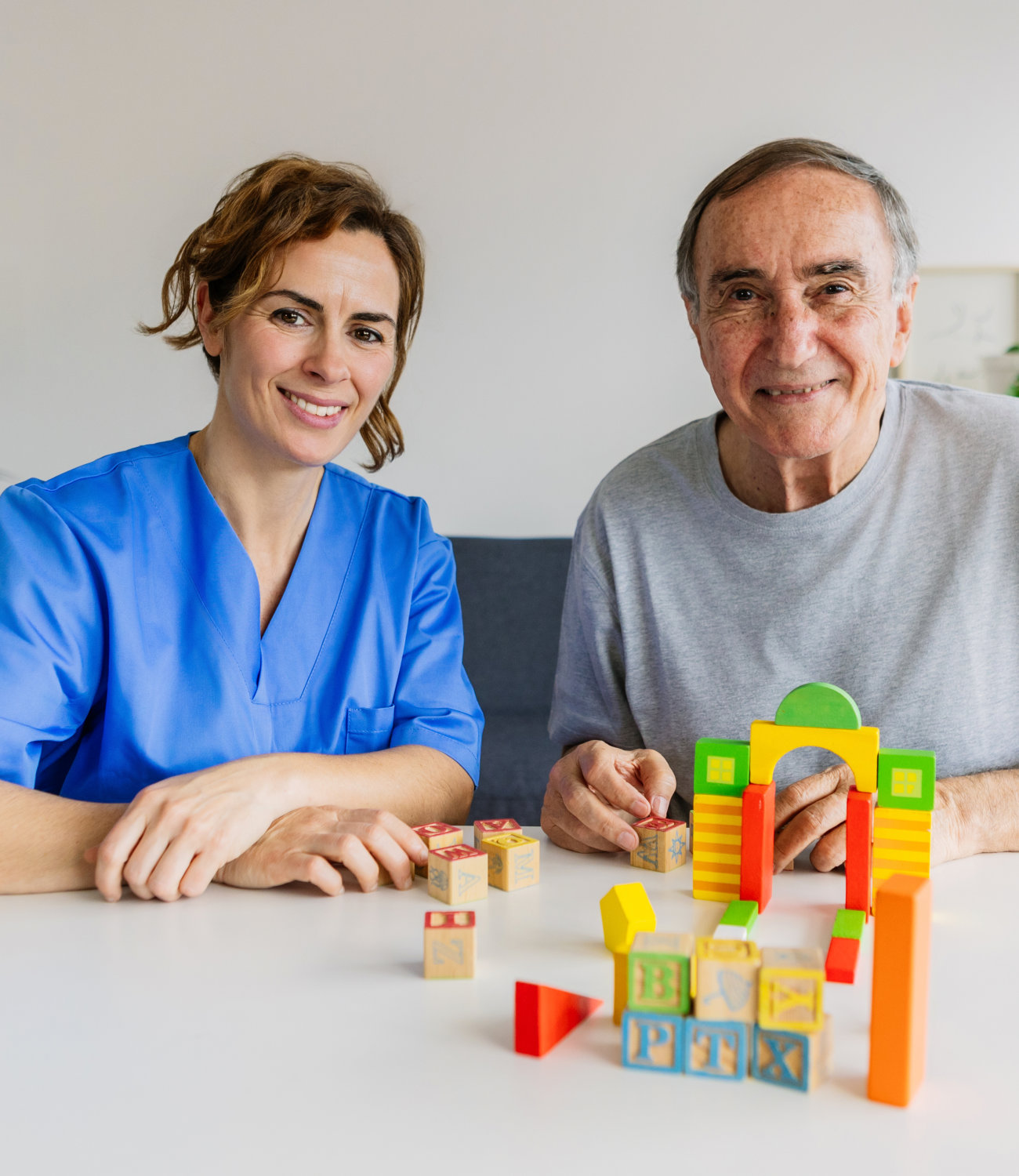 Caregiver and resident playing with blocks