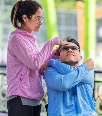 Staff assisting a resident outdoors.