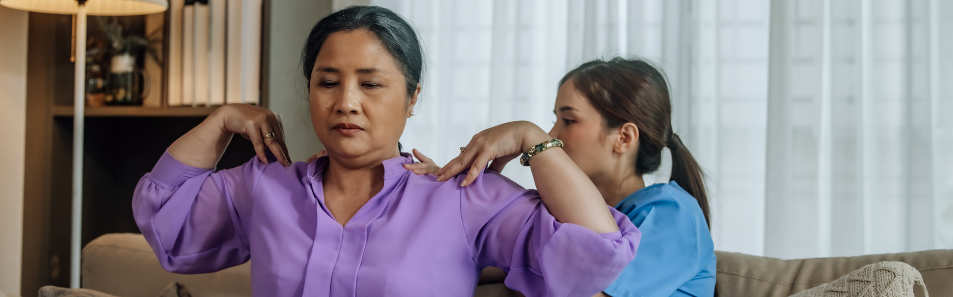 Caregiver assisting a resident in a common area