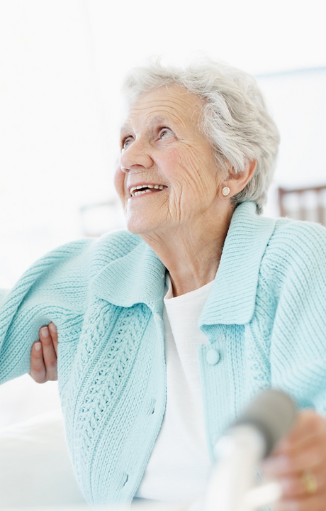 Elderly woman smiling in a cozy environment