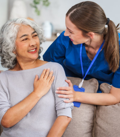 Caregiver interacting with a smiling resident.