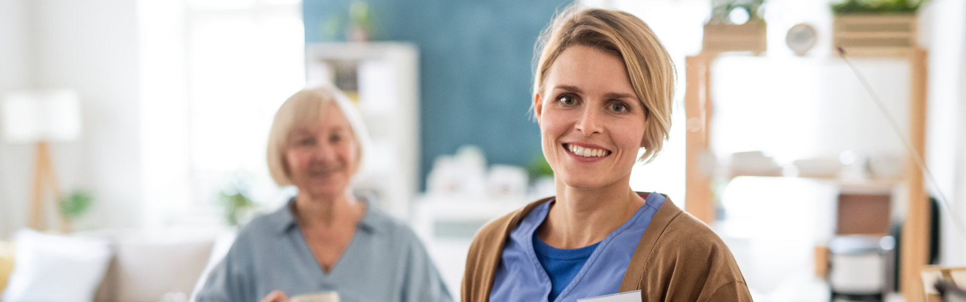 Staff member smiling with resident in common area