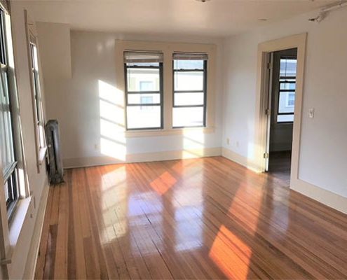 Bright and vacant room with wooden flooring