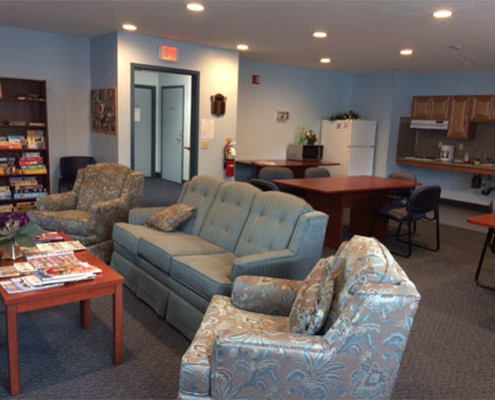 Common area with comfortable seating and bookshelves.