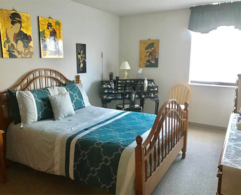 Cozy bedroom with artistic decor and a comfortable bed.
