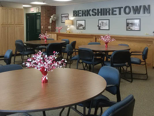 Common area with tables and flower decorations.