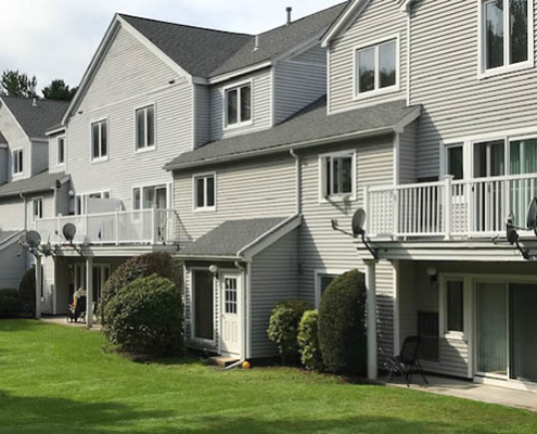 Exterior view of residential units with lawn.