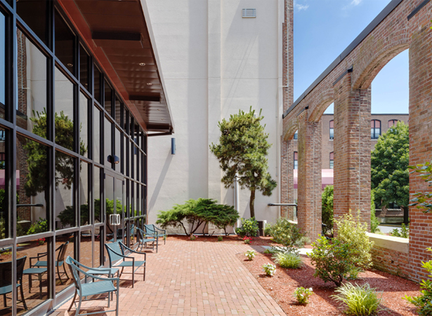 Outdoor patio area with benches and landscaping.