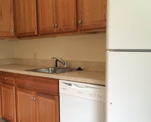 Facility kitchen area with cabinets and appliances.