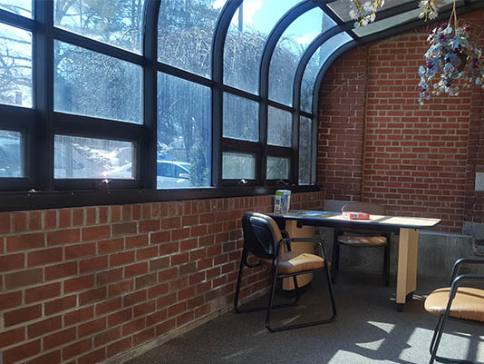 Bright interior seating area with large windows.
