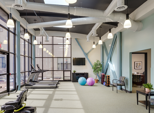 Bright, spacious fitness area with exercise equipment