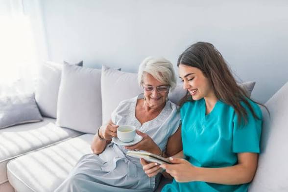 A caregiver and a senior woman enjoying time together.