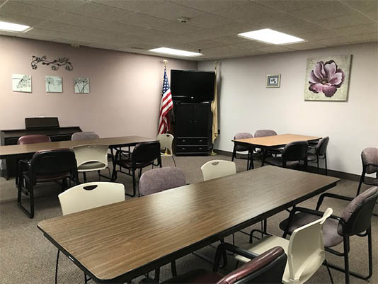 Interior view of a common room with tables and chairs