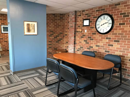 Meeting room with a wooden table and blue walls.