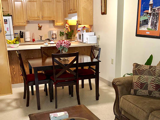 Cozy living space with dining area in a resident's unit.
