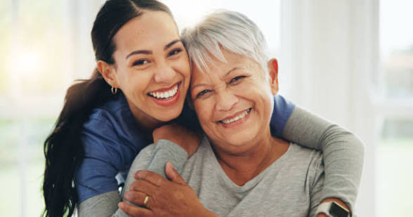 Caregiver and senior woman smiling together