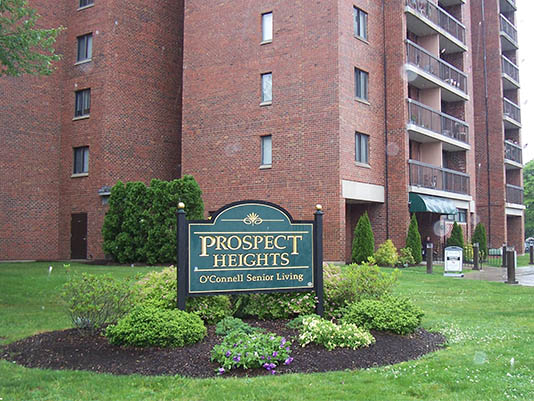 Exterior view of a senior living facility sign.