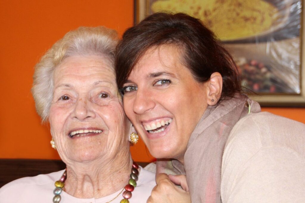 Senior woman smiling with caregiver