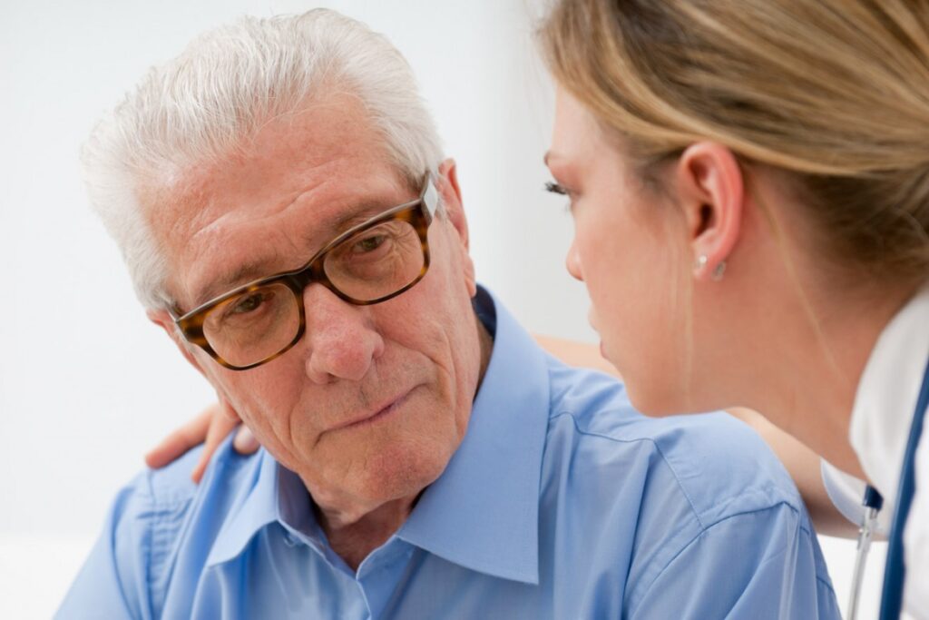Senior man converses with a caregiver