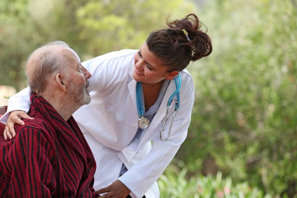 Caregiver interacting with a senior outdoors