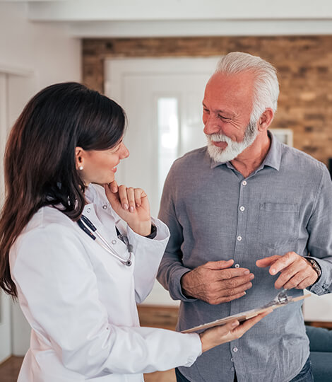 Healthcare professional interacting with a senior man