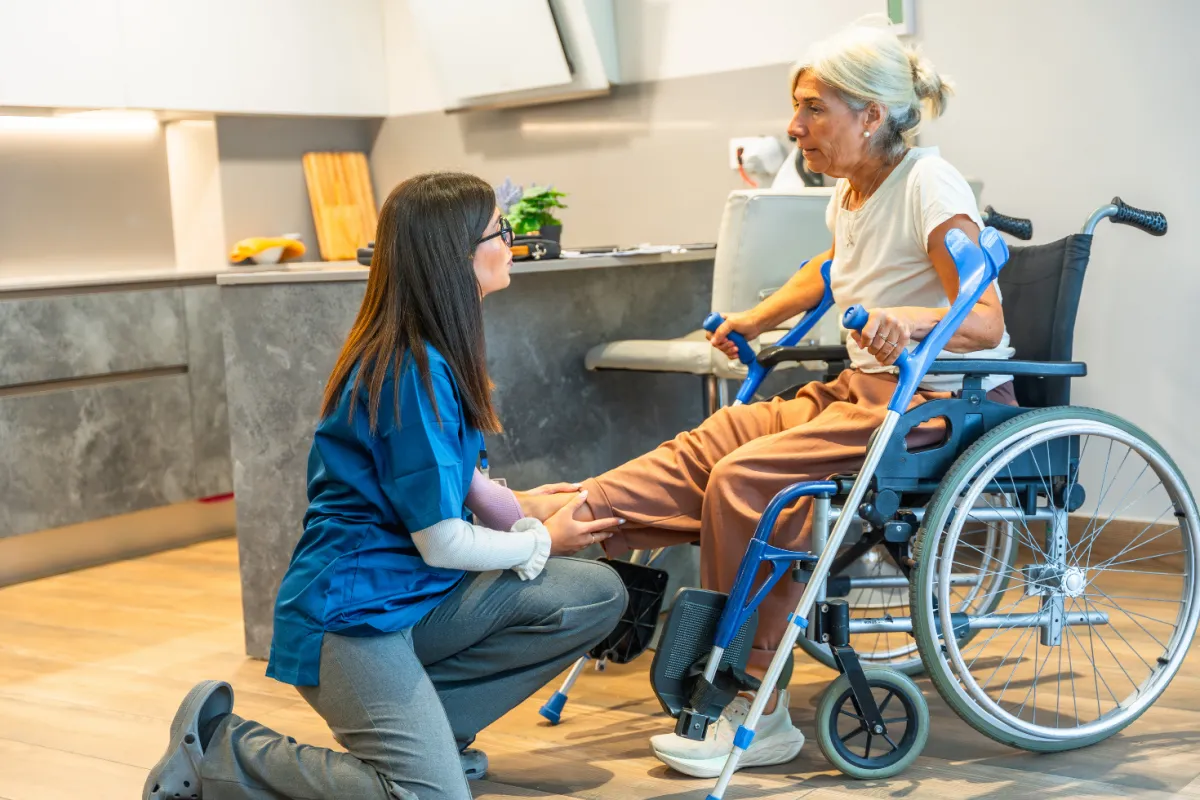 Staff assisting a resident in a living area