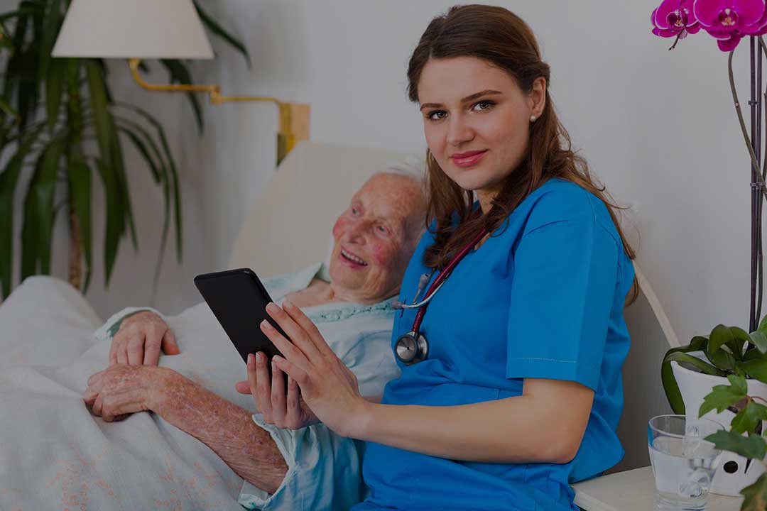 Nurse assisting an elderly resident in a cozy room.
