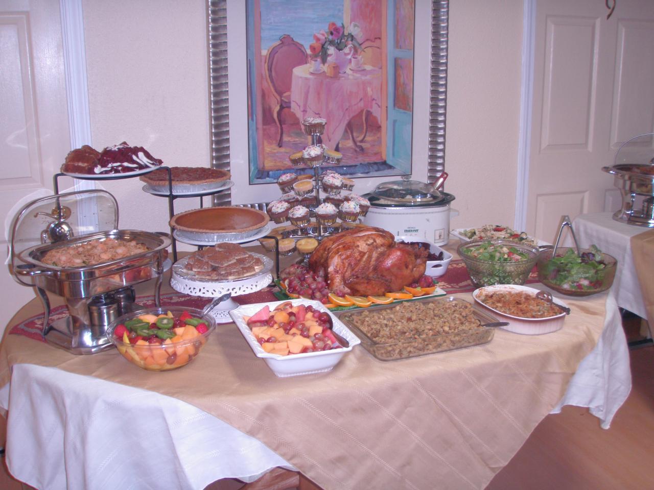 Catering setup with various dishes and desserts.