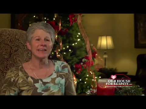 Senior woman speaking in a festive common area.