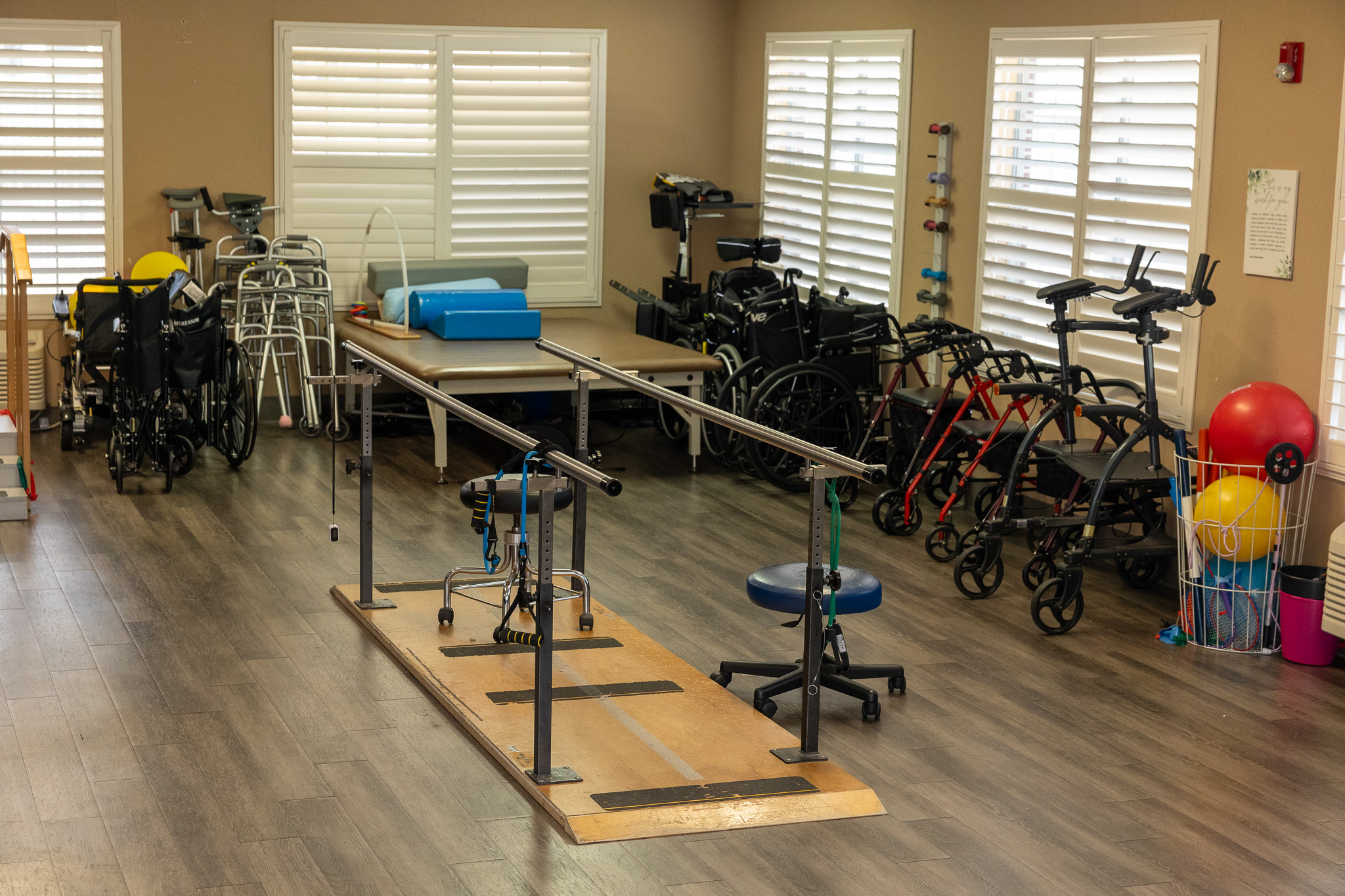Rehabilitation area with therapy equipment and mobility aids.