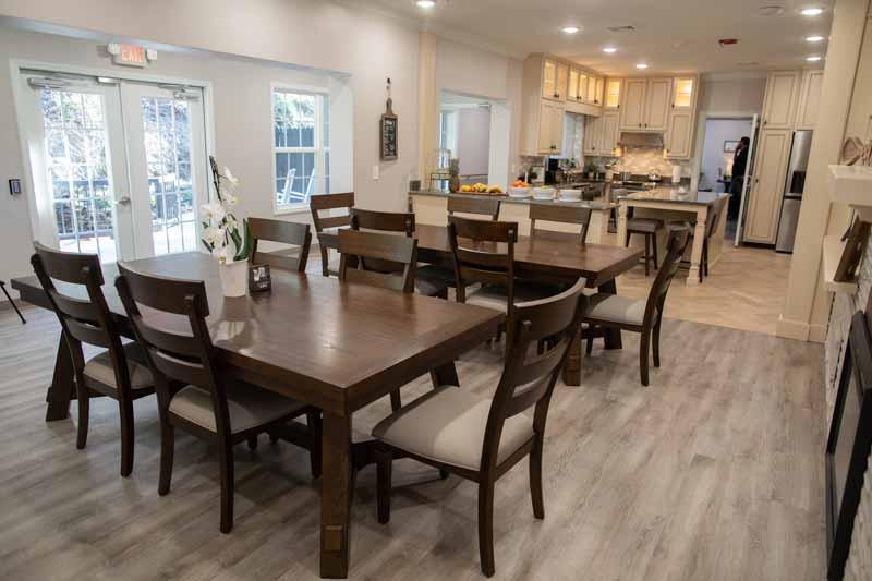 Bright dining area with wooden tables and chairs