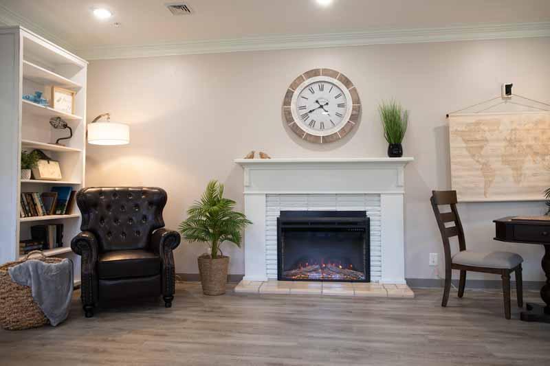 Cozy common area with a fireplace and seating.