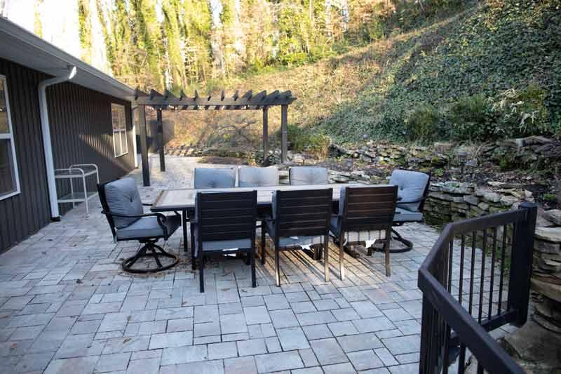 Outdoor patio area with seating and greenery