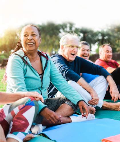 Residents participating in a group yoga session outdoors