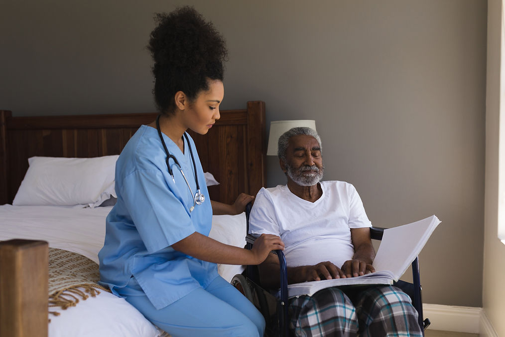 Nurse assisting an elderly man in a bedroom