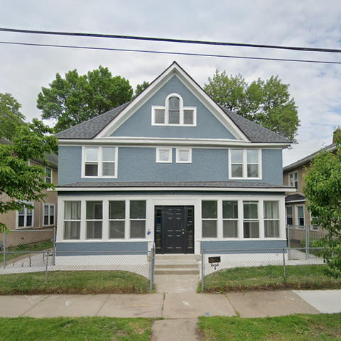 Exterior view of a blue assisted living facility.