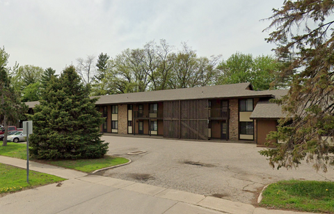 Exterior view of a residential building with trees.