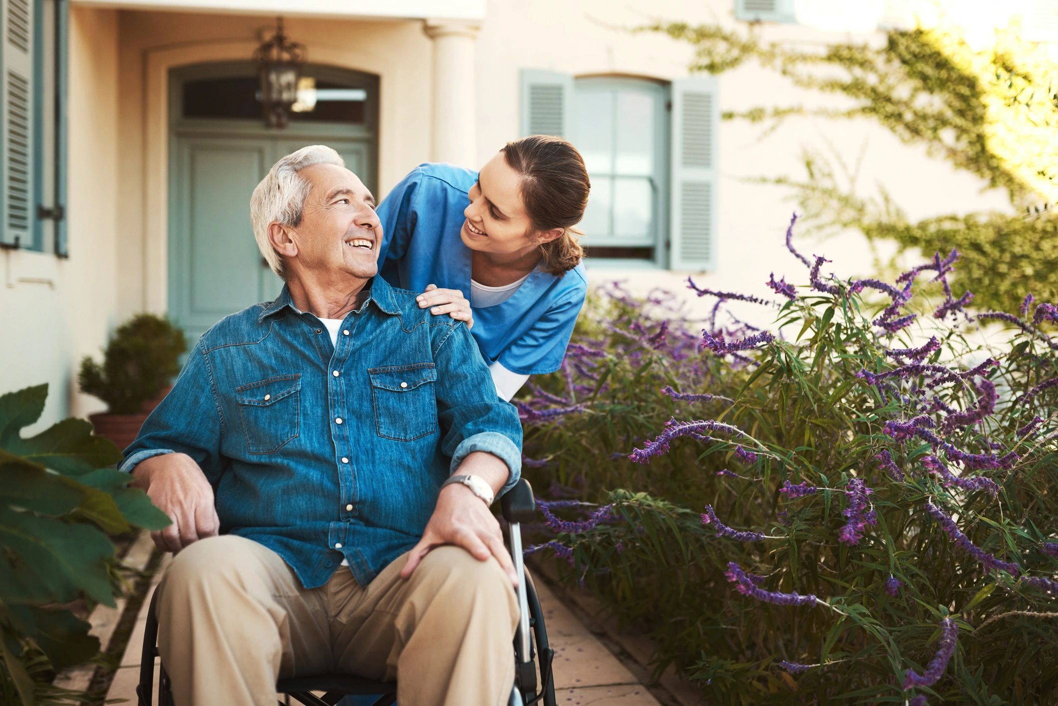 Caregiver interacting with a resident outdoors.