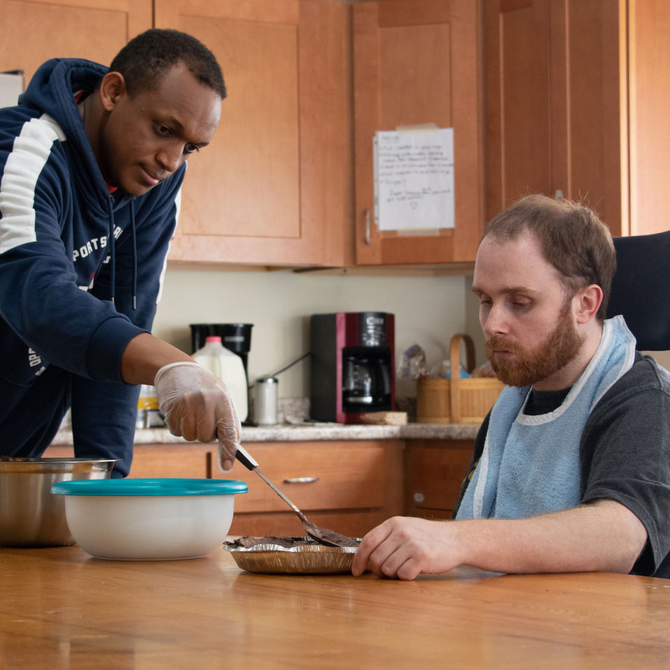 Staff assisting a resident with a meal